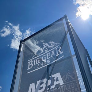 Trade show sign against a blue sky
