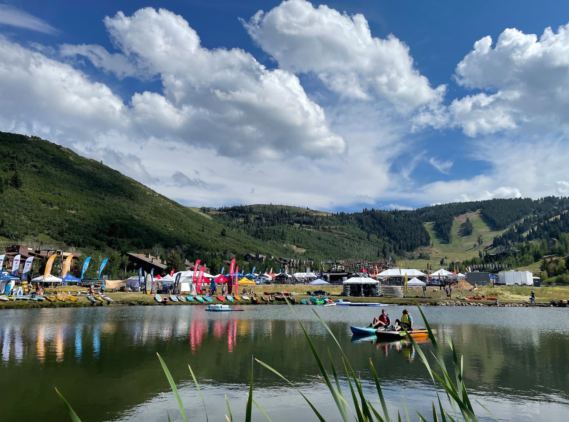 Outdoor trade show on a lake under a blue sky