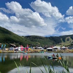 Outdoor trade show on a lake under a blue sky