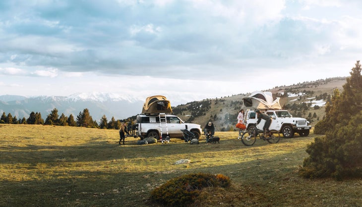 Rooftop tents on cars in a valley