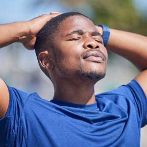 runner in blue shirt looking at sky as if visualizing