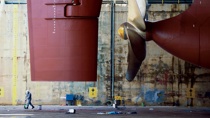 The propeller and rudder of a container ship in dry dock in Ulsan, South Korea