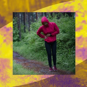 A person in a red raincoat holds their side