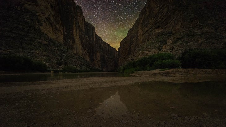 A nightscape from Big Bend National Park. The stars glow through the gap in Santa Elena Canyon.