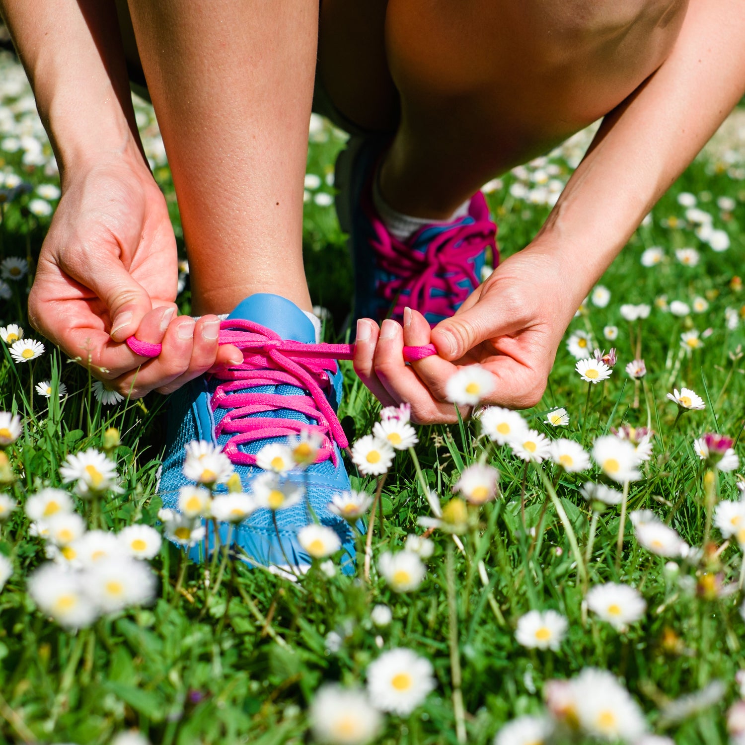 Female athlete getting ready for running in spring park. Fitness workout outdoor concept.