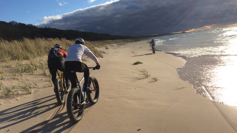 Three fat bikers on a Lake Michigan Beach.