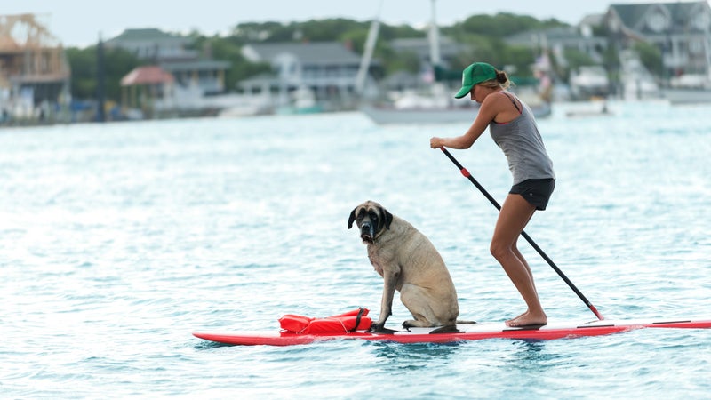 A woman and her dog paddling near Wrightsville Beach.