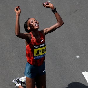 Rita Jeptoo, of Kenya,  celebrates her win in the women's division of the 118th Boston Marathon Monday, April 21, 2014 in Boston. (AP Photo/Charles Krupa)