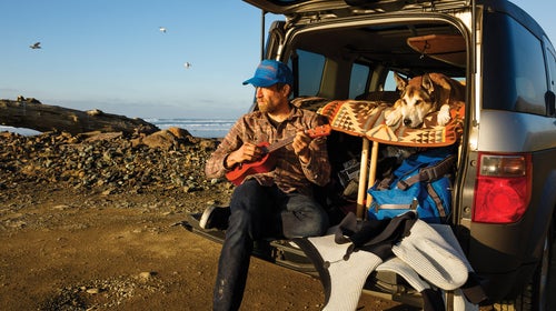 Ben Moon and his dog Denali relaxing on the Oregon coast while waiting for the surf to clean up.