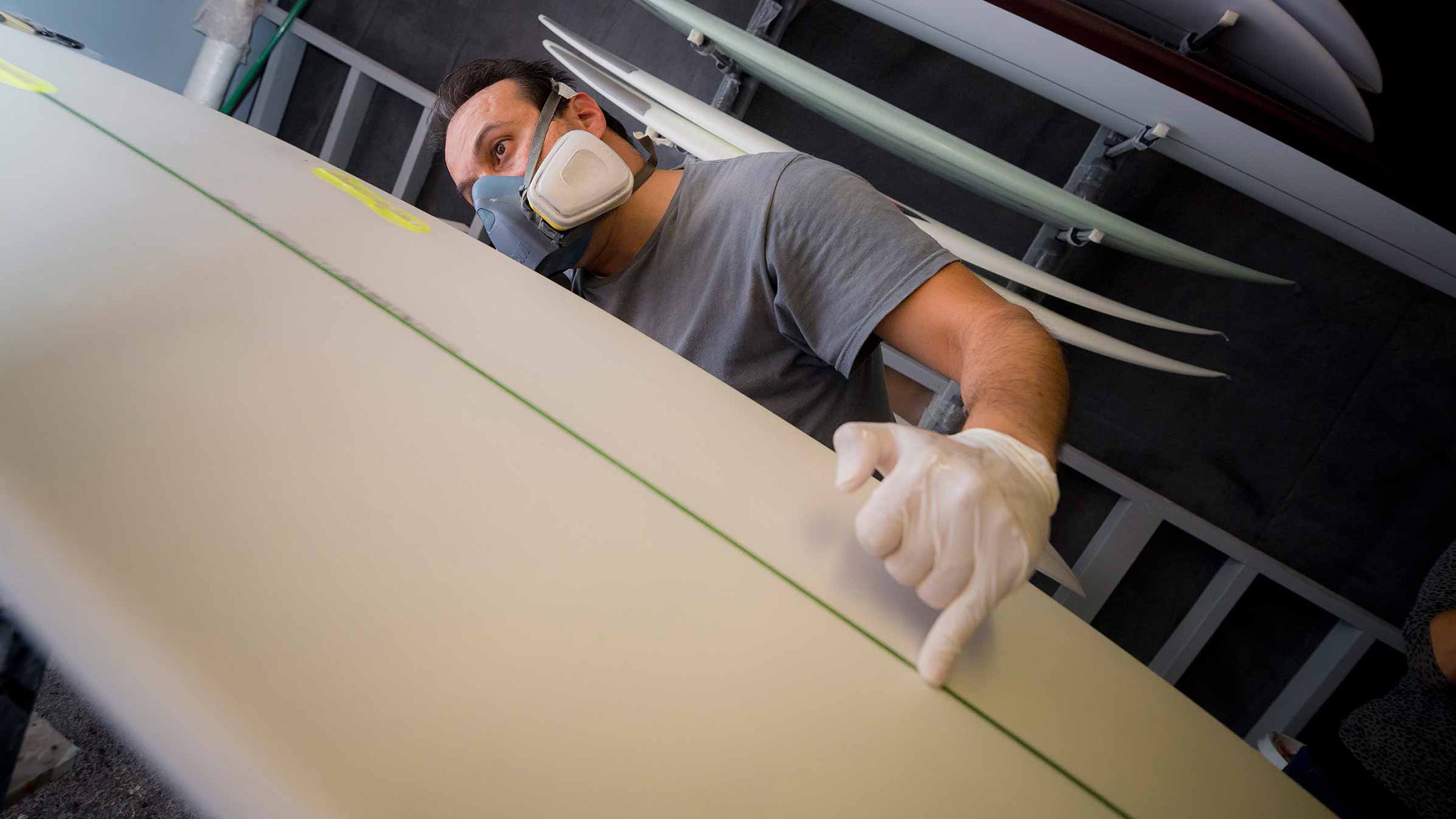 Workers at Avila Surfboards in Oceanside, California, prepare the world’s first algae surfboard blank for the application of a fiberglass shell.