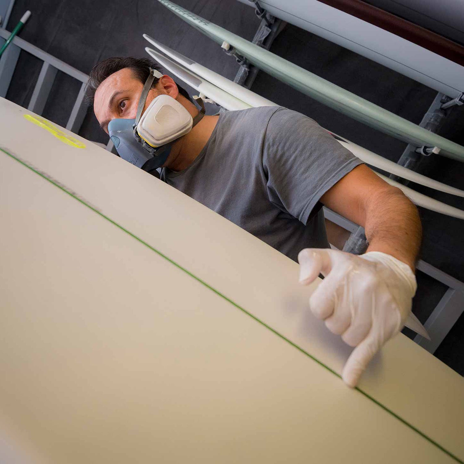 Workers at Avila Surfboards in Oceanside, CA prepare the world’s first algae surfboard blank for the application of a fiberglass shell.