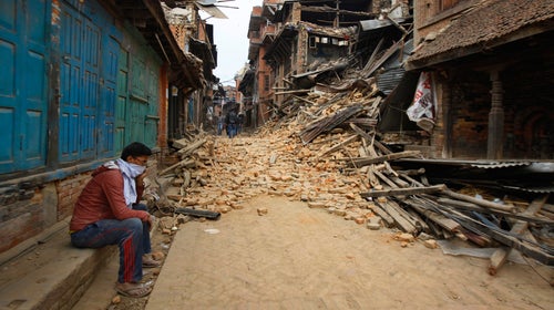 A Nepalese man mourns as he sits near the debris after an earthquake in Bhaktapur near Kathmandu, Nepal, Sunday, April 26.