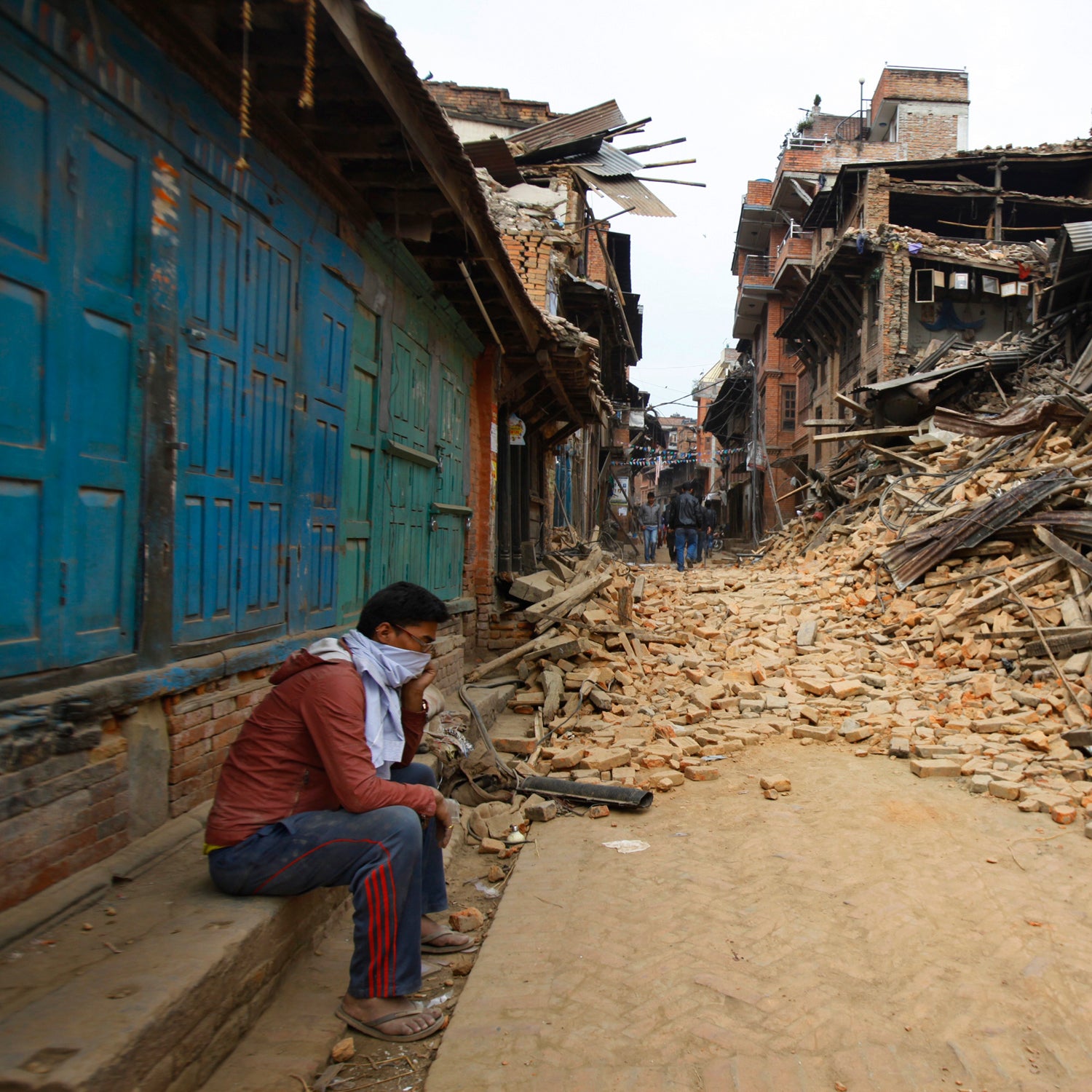 A Nepalese man mourns as he sits near the debris after an earthquake in Bhaktapur near Kathmandu, Nepal, Sunday, April 26.