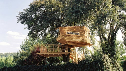 The structure was a gift from a wife to her husband and sits nestled in a pear tree above orchards and vineyards. Windows and skylights ensure occupants maintain a connection with the outdoors, while a spacious terrace allows the couple to admire their property.