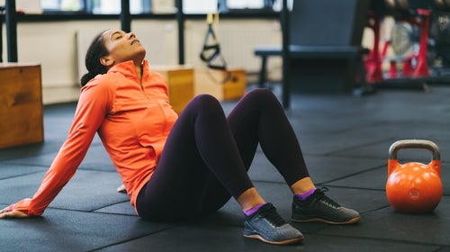 Exhausted sportswoman in the gym, working out when tired
