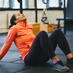 Exhausted sportswoman in the gym, working out when tired