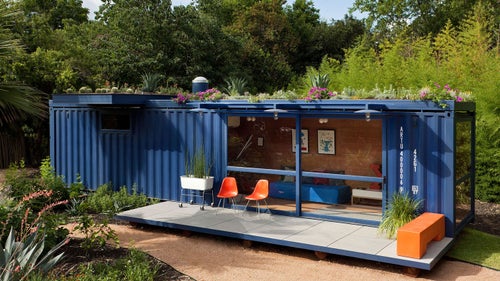 San Antonio's Poteet Architects made this structure from a recycled royal blue container. The space opens to its surrounding with sliding-glass doors and floor-to-ceiling windows. A green roof provides insulation and generous overhangs provide patio shade, while an interior clad in bamboo plywood breeds an air of relaxation.