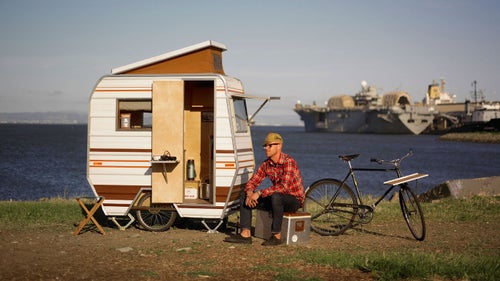 A personal reaction from creator Kevin Cyr to the economic downturn, the mini camper allows inhabitants to weather their worst-case scenarios. In the spirit of minimalism, the camper is towed by a vintage, three-speed Raleigh bicycle. The camper鈥檚 interior is stocked with goods that call to mind a childhood camping trip.