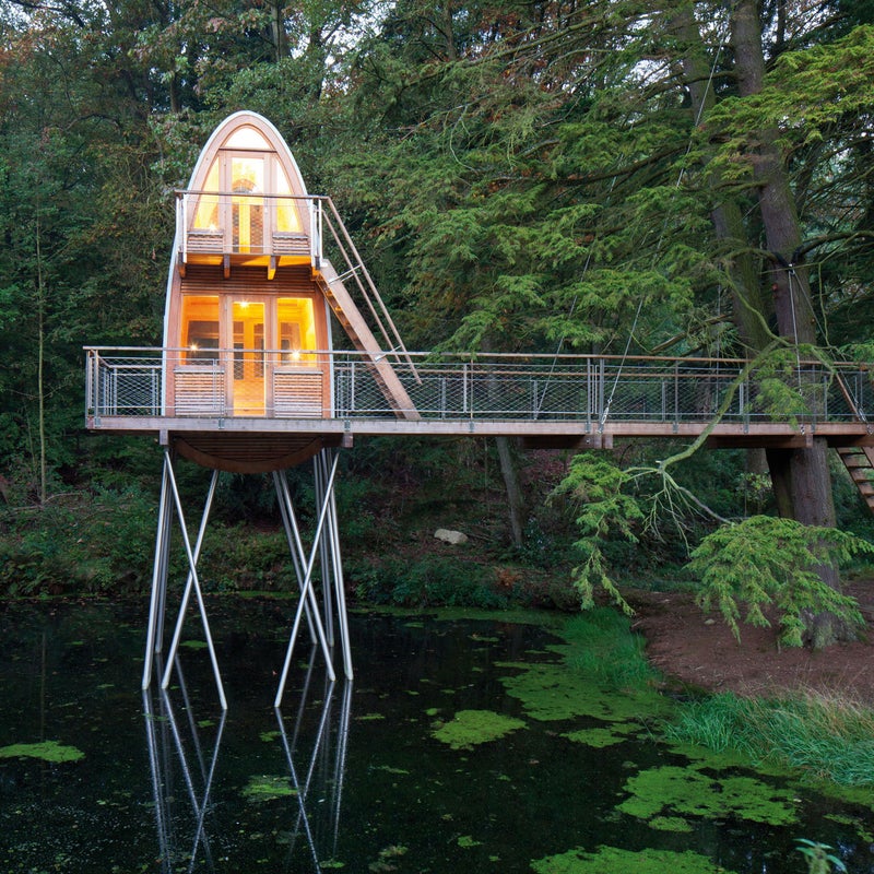 This two-story treehouse towers above the pond below and connects to nearby hemlock spruce trees by a terrace. Visitors may enter the treehouse directly from the terrace or choose to climb another external stairway to reach the sleeping area above. During the day, the upper-level serves as the ideal vantage point for viewing surrounding wildlife, and at night, the domed skylight allows inhabitants a brilliant view of the stars.