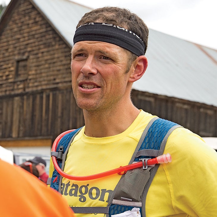 Justin Angle, who also suffers from overtraining syndrome, at a race wearing a yellow shirt and sweatband