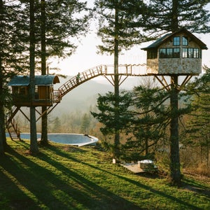 The finished Cinder Cone. A suspension and arched bridge 40 feet off the ground connects two treehouses.