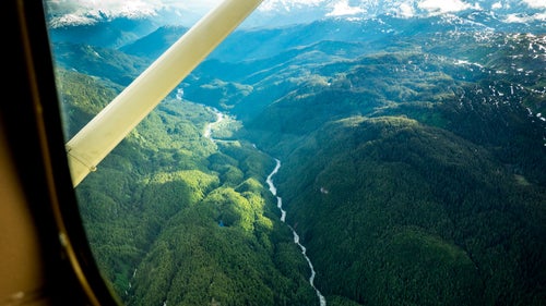 In July, 2014, conservationists and adventurers Ryan Peterson, Travis Rummel, and Gordon Klco dropped into a mountainous fortress of old growth rainforest at the source of the Unuk River in British Columbia. Ten days and 100 miles later they floated into Burroughs Bay in Misty Fjords National Monument in Alaska having completed a first source to sea descent. The expedition was undertaken as part of production for the short film, Xboundary, which discusses the region’s transboundary rivers in light of an open-pit mining boom at their British Columbia headwaters. Downstream in Alaska, these rivers are the foundation of billion-dollar salmon and tourism industries, and residents are concerned over pollution risks posed to their economy and culture. Here, Peterson walks us through a selection of the group’s images and highlights critical portions of the trip and this fragile region. Photo: Pre-trip hopes for an all-water float trip were annihilated by aerial views of impassable waterfalls and logjams—we’d have to hike. As the cessna banked hard over the upper Unuk, Rummel filled his sick sack, portending a gnarly five-day bushwhack down the (left) ridgeline—a hellish maze of colossal deadfall, granite boulders, and thorny devils club under near-dark spruce and hemlock canopy.