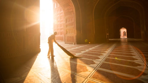 Dust sparkled in the early morning rays as the sun warmed our bare feet on the cool floors of the Taj Mahal mosque.
