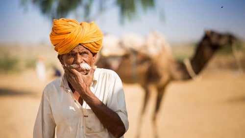 It was hot and dusty as I walked through a small desert village near Jaisalmer, India, when this man appeared. I froze in awe and fumbled for my camera before he stopped long enough for a few snaps of the shutter.