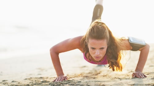 Create a packed workout on the beach by mixing strength training on land with swimming.
