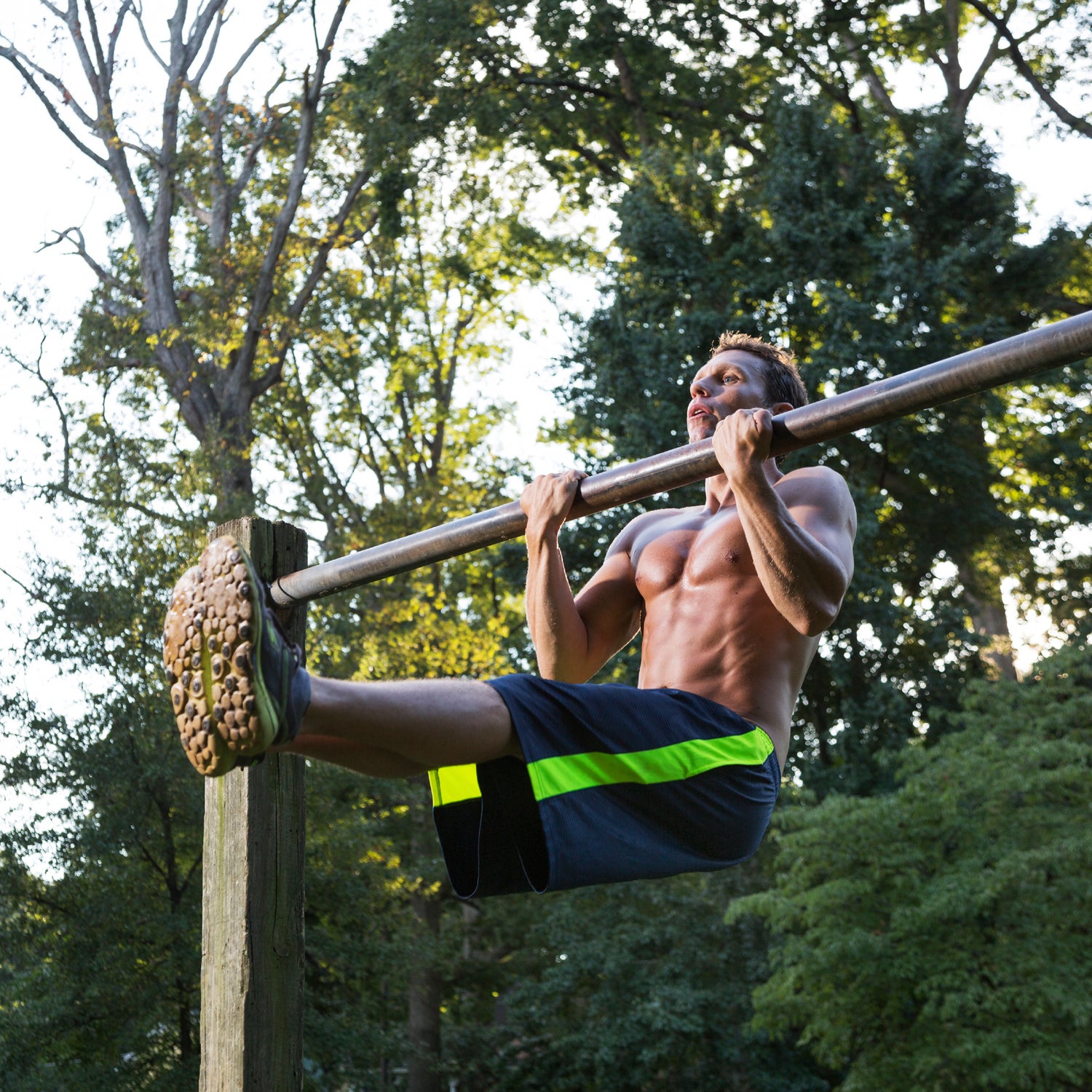 Premium Photo  Muscular man performing hanging leg raises exercise one of  the most effective ab exercises
