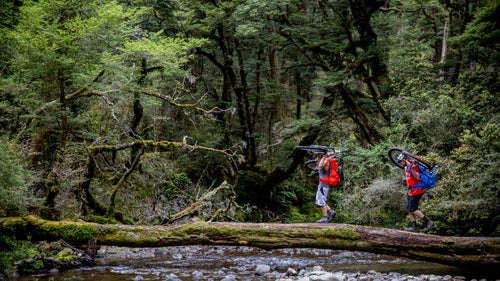Riders Traharn Chidly and Mike Hopkins make one of the river crossings on the Te Iringa trail.