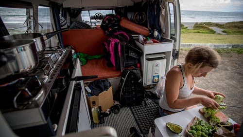 Brown cooking in our camper. The produce, purchased from roadside stalls, was all grown on land we passed through. Life on the road was humbling. Showers were limited at our chosen campsites, and we powered our electrics with Goal Zero solar chargers and happily lived off the grid.