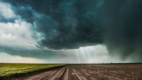 Dirt roads and storm chasing don鈥檛 mix鈥攖he last thing you want is to be stuck in mud as a hail-filled supercell approaches. The crepuscular rays of light give scale to this otherwise ominous supercell that was bearing down on us.