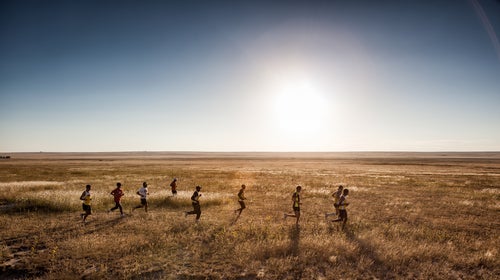Runners pursue a pronghorn antelope over the plains of Northern New Mexico in August 2014.