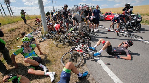 Riders lie on the road after crashing during the third stage of the Tour de France on July 6.