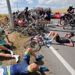 Scores of riders lie on the road after crashing during the third stage of the Tour de France cycling race over 159.5 kilometers (99.1 miles) with start in Antwerp and finish in Huy, Belgium, Monday, July 6, 2015. (AP Photo/Christophe Ena)