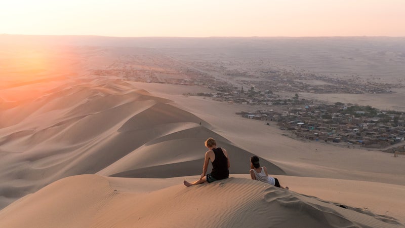 Sun setting over the sand dunes of Huacachina, Peru.