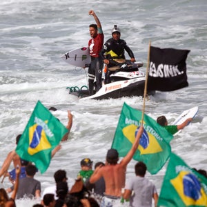 Brazil's Filipe Toledo celebrates after winning the World Surf League (WSL) Rio Pro championship in Rio de Janeiro, Brazil, Sunday, May 17, 2015. Toledo defeated Australia's Bede Durbidge and won the championship. (AP Photo/Felipe Dana)