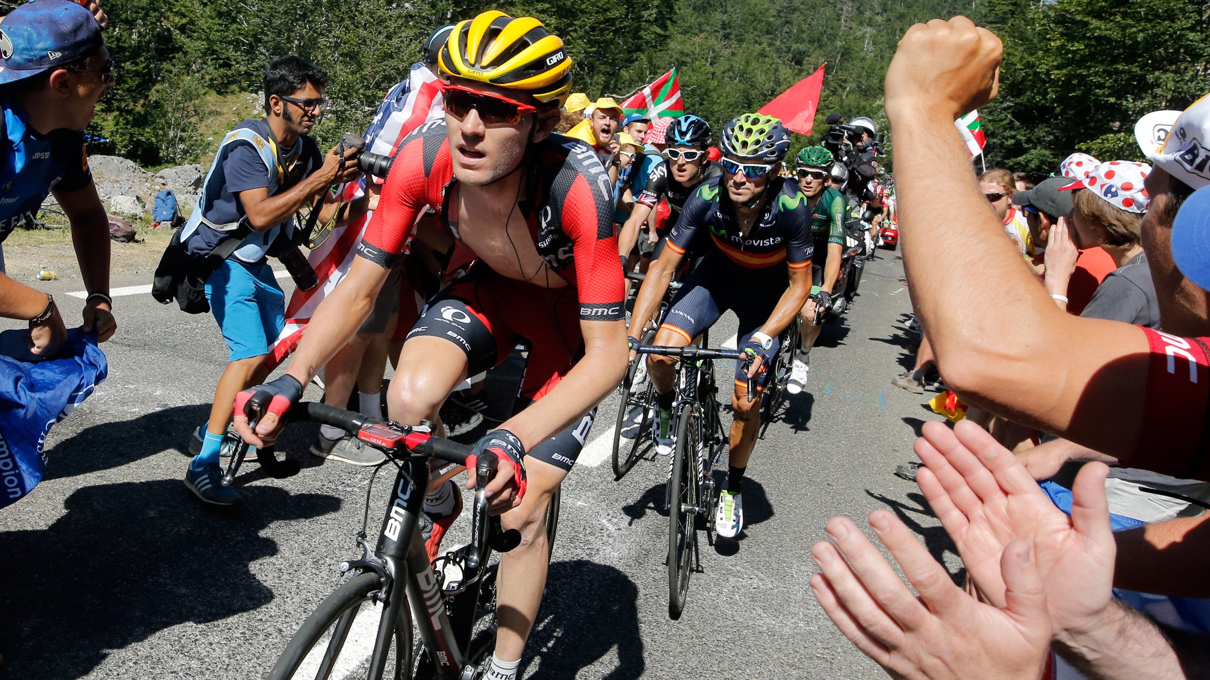 A teammate helps Tejay van Garderen (left) after he fell ill during the Stage 17 of the Tour de France.