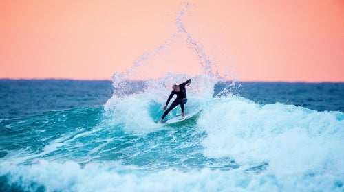 Mick Fanning (pictured surfing in Australia in April 2015) said he felt the great white shark tangle with his leash before the fin surfaced.