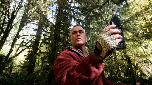 Gordon Hempton uses a sound level meter on the Hoh River Trail.