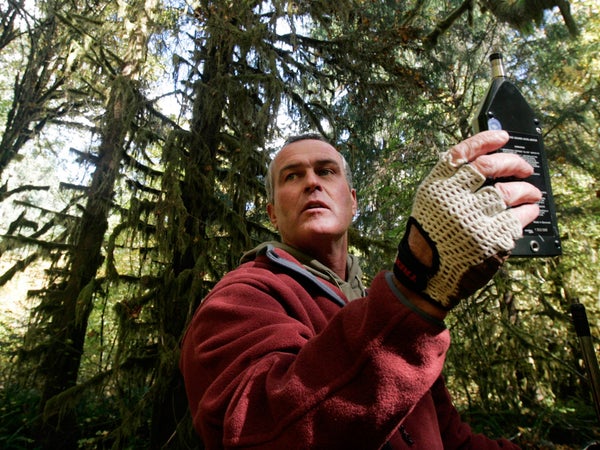 Gordon Hempton uses a sound level meter on the Hoh River Trail.