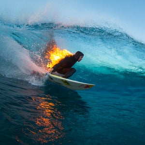 Jamie O'Brien surfs while lit on fire, at Teahupoo, Tahiti in July.