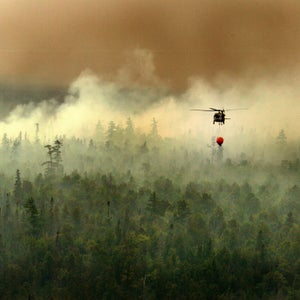The Michigan Army National Guard uses a bambi bucket, an aerial firefighting tool suspended below a helicopter, to extinguish a fire 10 miles from Tahquamenon Falls State Park, Mich., Aug. 8, 2007. (U.S. Army photo by Staff Sgt. Helen Miller) (Released)