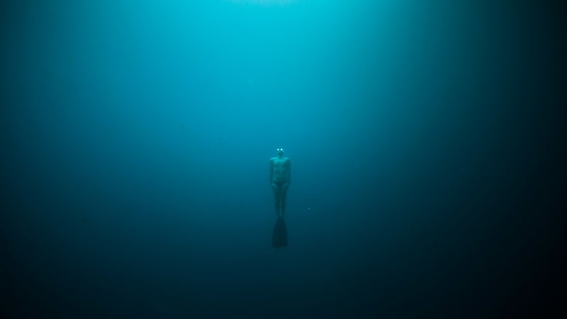 Yoram Zekri free dives in the Matavulu Blue Hole on the island of Espiritu Santo, Vanuatu.