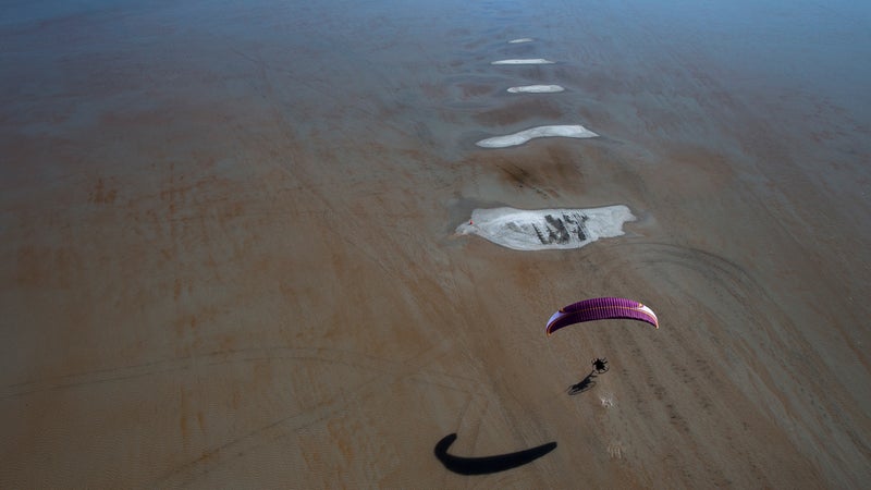 Shane Denherder para-motoring above the flooded Bonneville salt flats in Utah.