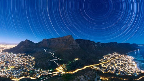 The World at Night’s annual International Earth and Sky photo contest was started in 2009 to promote the night sky as a natural wonder in need of protection. In conjunction with the volunteer and conservation efforts of the U.S. nonprofit Astronomers Without Borders and the National Optical Astronomy Observatory, the contest brings together nature photographers from around the world to give us a clearer look at what the sky should look like–without any light pollution. The result? A collection of photographs that capture the stuff of stargazers’ dreams.
Photographers hailing from 54 countries submitted more than 1,000 images this year. They follow a simple criteria: Include both the the Earth and the sky and pay “special attention” to astronomical perspectives and celestial phenomena. Here a few of 2015’s winners.
Photo: Star Trails Above Table Mountain
UK traveling photographer Eric Nathan, who has photographed in 87 countries, was awarded first place in the Against the Lights category for this image. The cityscape lights of some of Cape Town’s 987,007 inhabitants are juxtaposed against the flat-topped Table Mountain and the star trails above it. It is comprised of a stack or compilation of over 900 thirty-second exposures, all captured in June 2014.