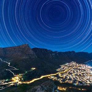 The World at Night’s annual International Earth and Sky photo contest was started in 2009 to promote the night sky as a natural wonder in need of protection. In conjunction with the volunteer and conservation efforts of the U.S. nonprofit Astronomers Without Borders and the National Optical Astronomy Observatory, the contest brings together nature photographers from around the world to give us a clearer look at what the sky should look like–without any light pollution. The result? A collection of photographs that capture the stuff of stargazers’ dreams.
Photographers hailing from 54 countries submitted more than 1,000 images this year. They follow a simple criteria: Include both the the Earth and the sky and pay “special attention” to astronomical perspectives and celestial phenomena. Here a few of 2015’s winners.
Photo: Star Trails Above Table Mountain
UK traveling photographer Eric Nathan, who has photographed in 87 countries, was awarded first place in the Against the Lights category for this image. The cityscape lights of some of Cape Town’s 987,007 inhabitants are juxtaposed against the flat-topped Table Mountain and the star trails above it. It is comprised of a stack or compilation of over 900 thirty-second exposures, all captured in June 2014.