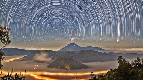 Malaysian photographer Hui Chieh Teoh created this long exposure image of star trails around the south celestial pole above the steaming volcanoes of Bromo Tengger Semeru National Park of East Java, Indonesia, in June 2014. It won fourth place in the Against the Lights category.