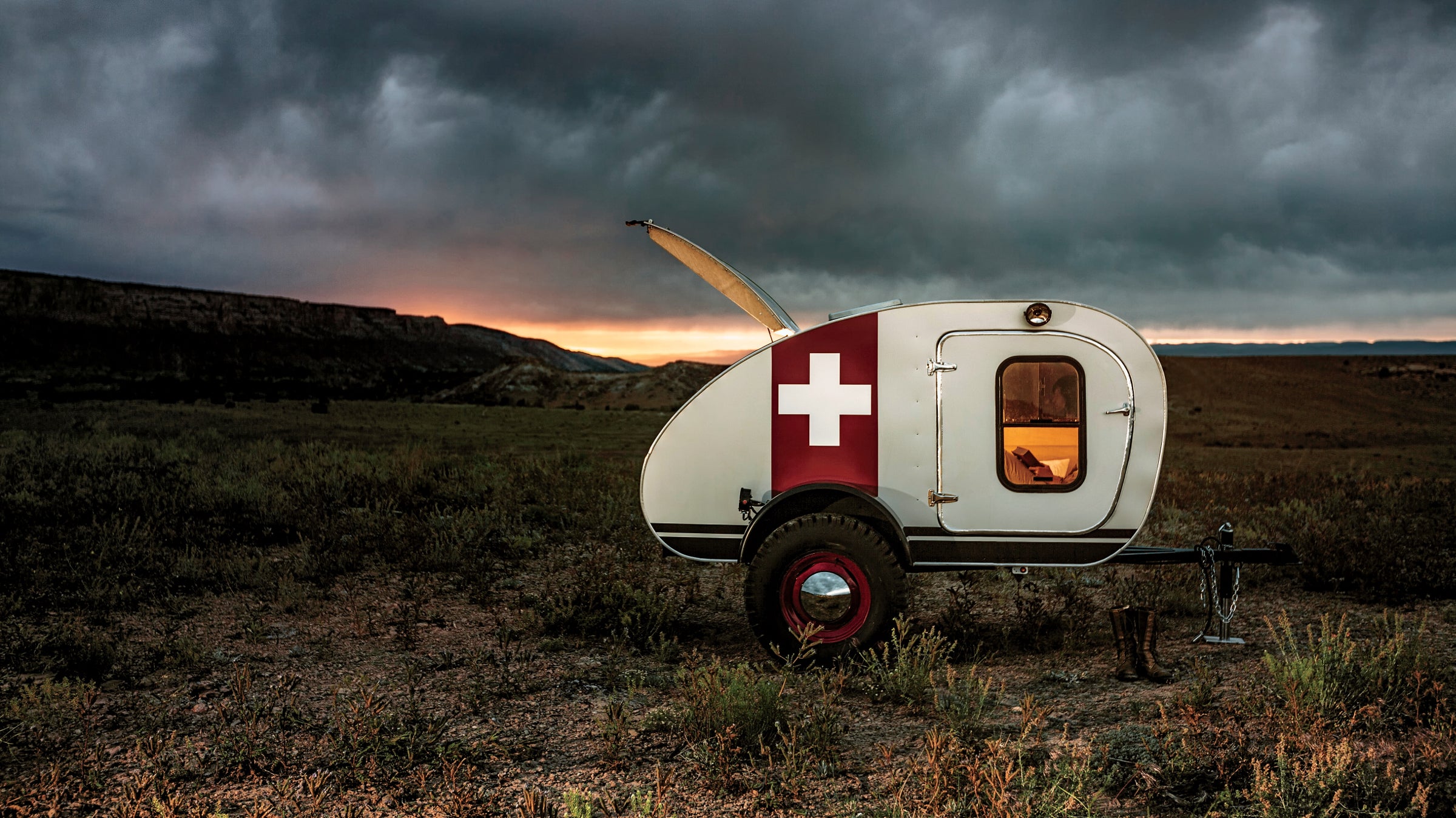 Trailer features include a storage boot for your camp kitchen, a five-by-eight-foot cabin with memory foam mattress, and a torsion axle with moon hubcaps and off-road tires.
